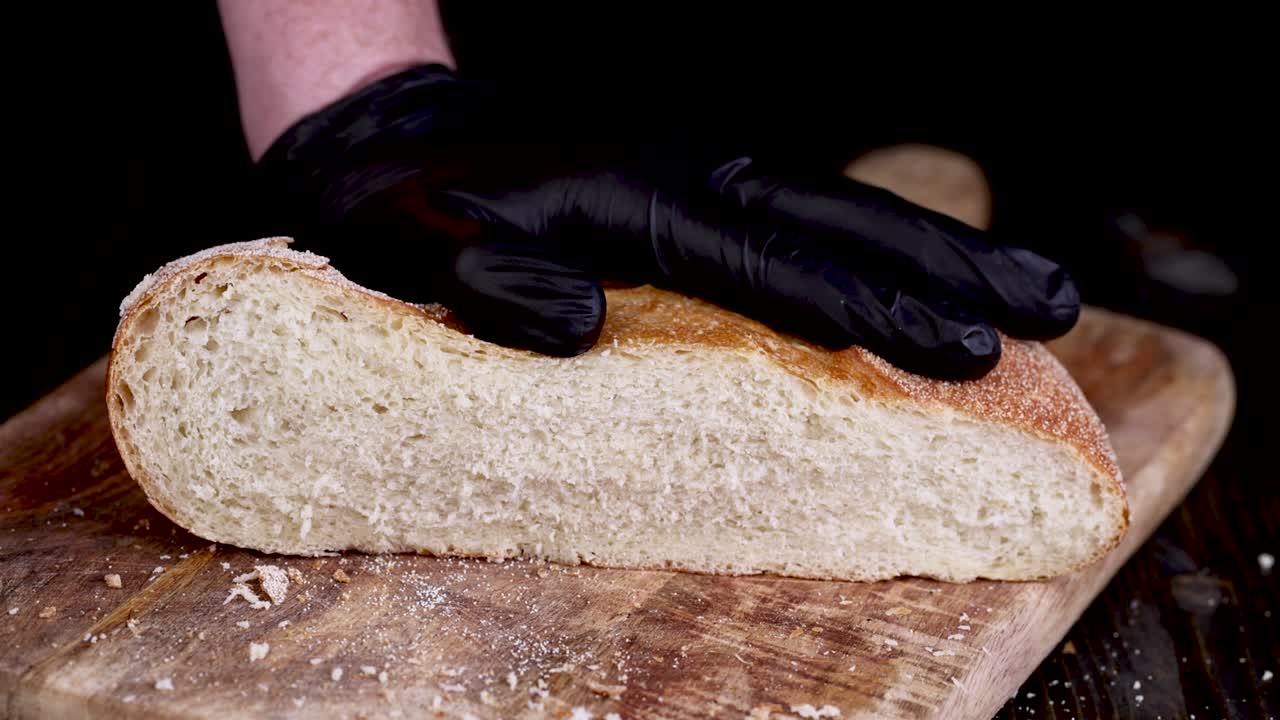 pressing on a loaf of bread from above