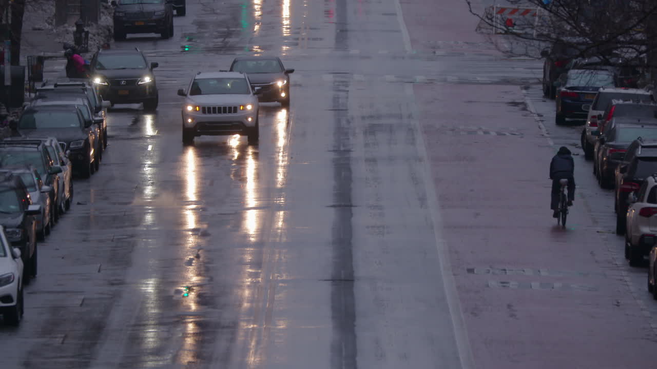 눈이 내리는 겨울에 교통 체증이 있는 젖은 뉴욕 맨하탄 메인 스트리트의 슬로우모션