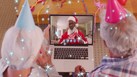 animation of snow falling text over senior caucasian couple on laptop video call with family