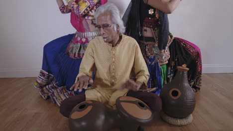 indian percussion musician with dancers 08