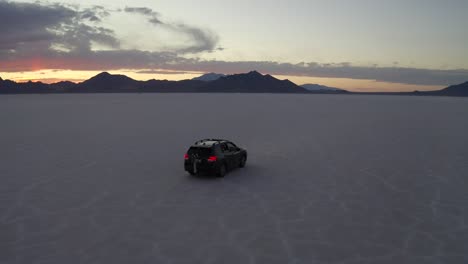 suv races across open salt flat desert in utah