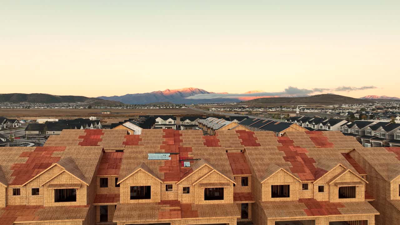 Rising Aerial Shot Of New Housing Development Revealing Farm Land Sold For Housing In Saratoga Springs, Utah at sunrise