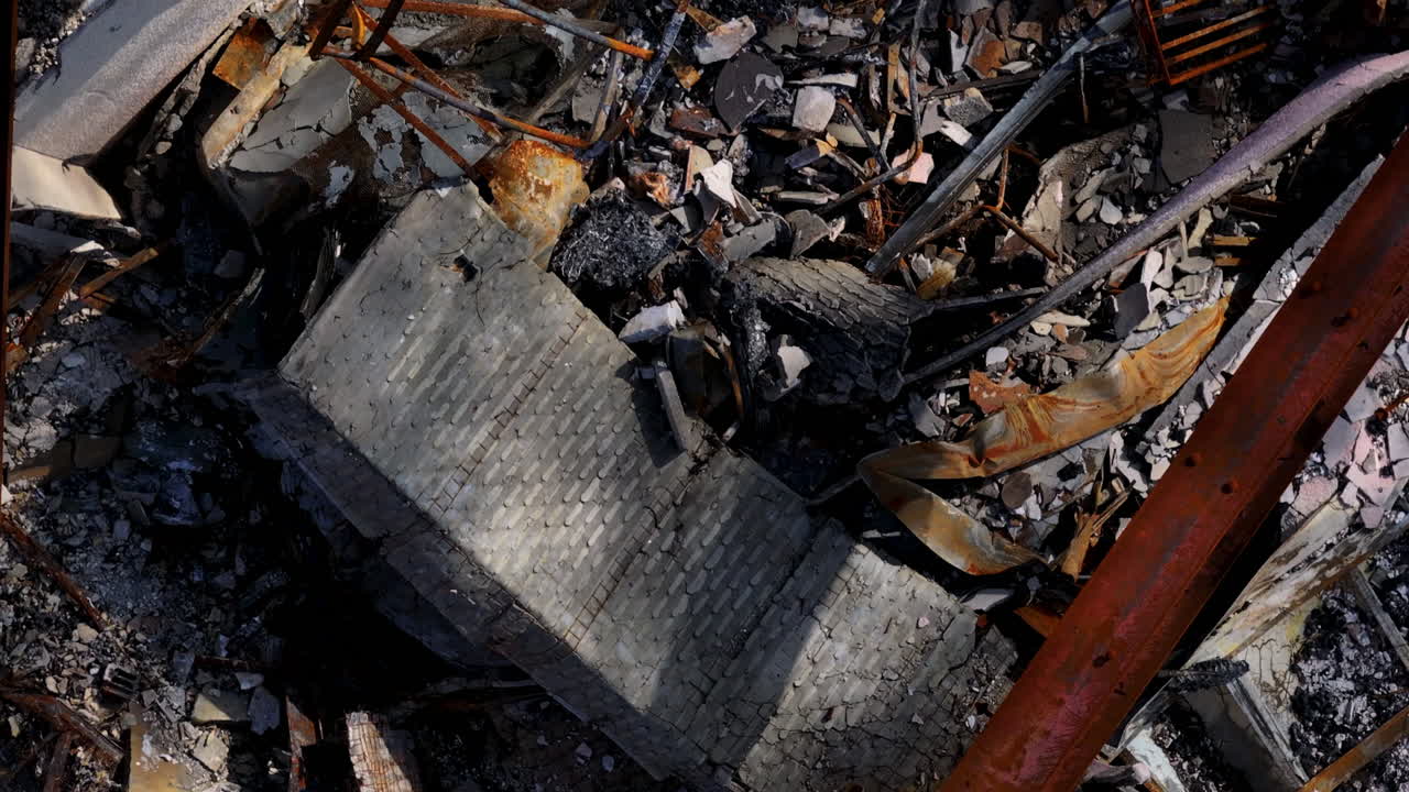 Aerial view of a devastating fire aftermath, showing charred remains and rubble