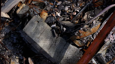 aerial view of a devastating fire aftermath, showing charred remains and rubble