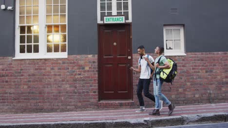 two mixed race male friends walking and looking for hostel in the street