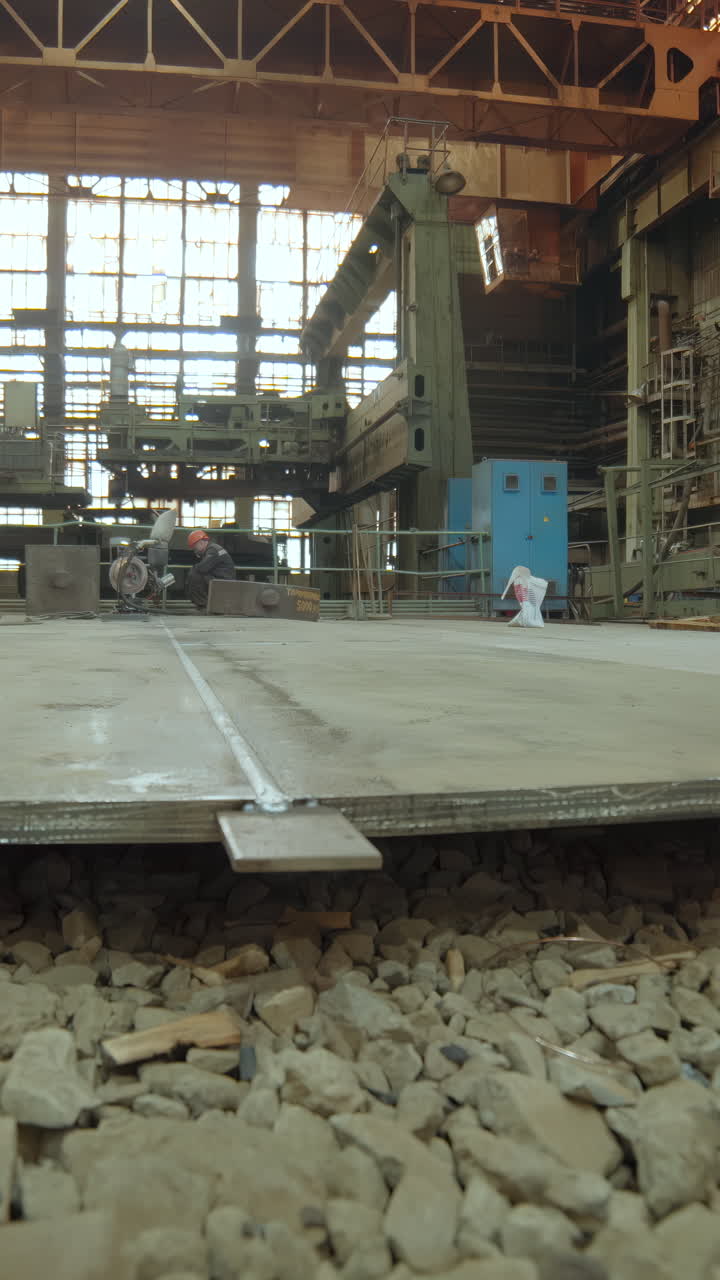 Large scale industrial factory with workers and heavy machinery
