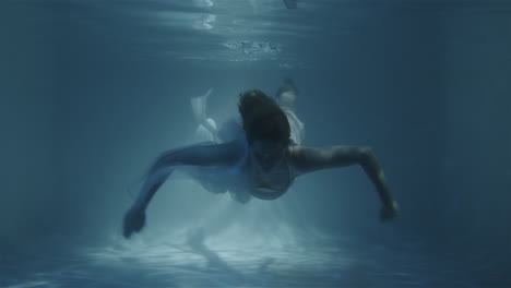 a girl in a white dress floats to the camera in slow motion