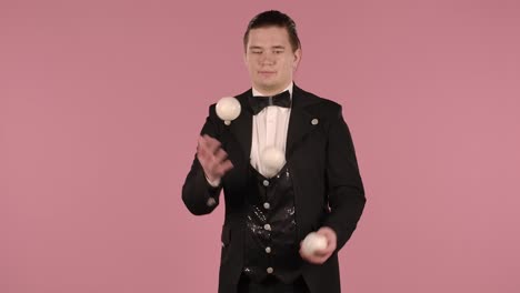 hombre haciendo malabarismos con bolas en traje negro