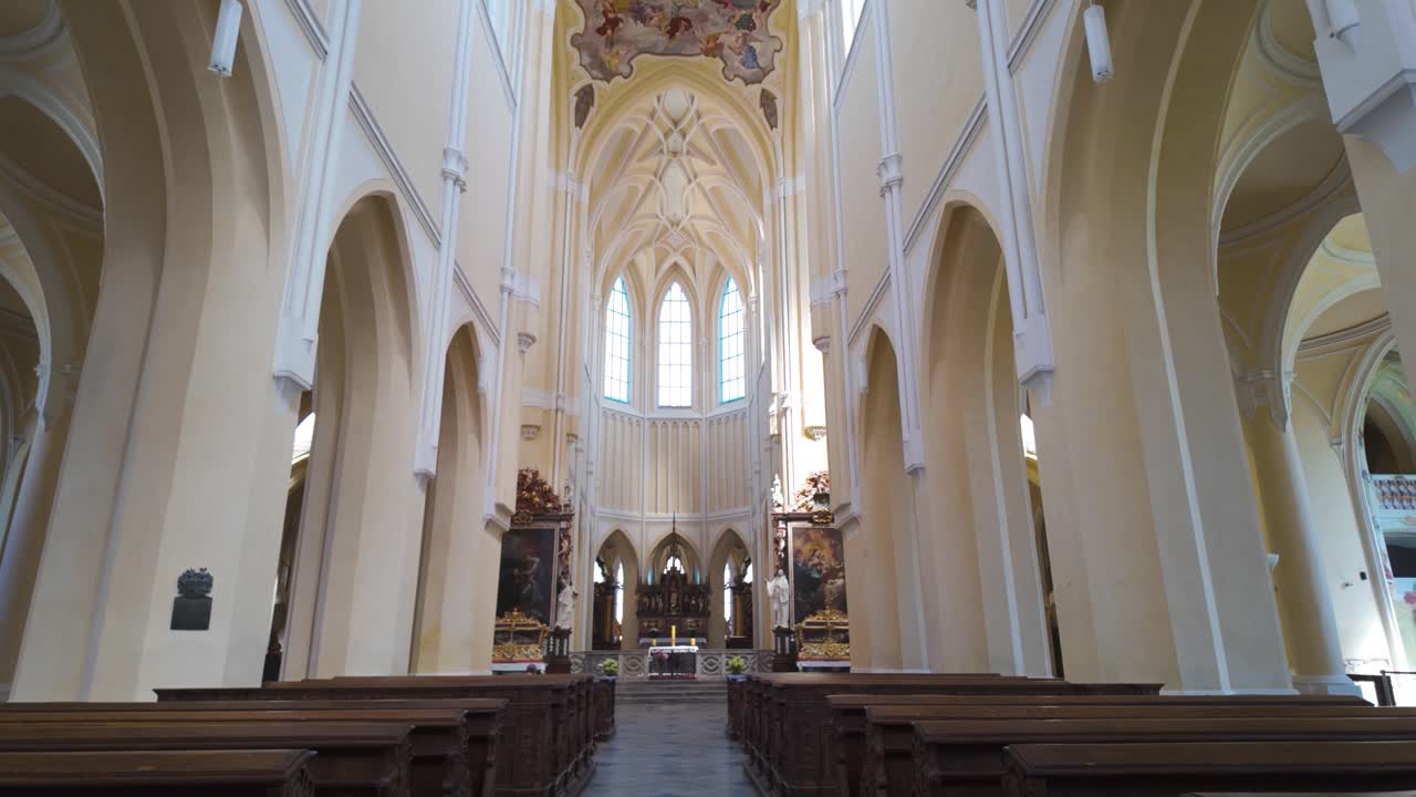 View of the Cathedral of Assumption of Our Lady and St. John the Baptist in Kutná Hora, featuring Gothic-style arches.Tilt Down Shot From Ceiling
