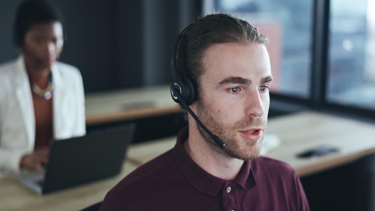 Call center, headset and a man talking at his desk