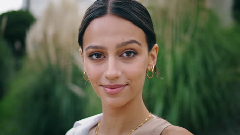 Closeup-smiling-girl-looking-camera-outdoors.-Portrait-happy-woman-posing-nature