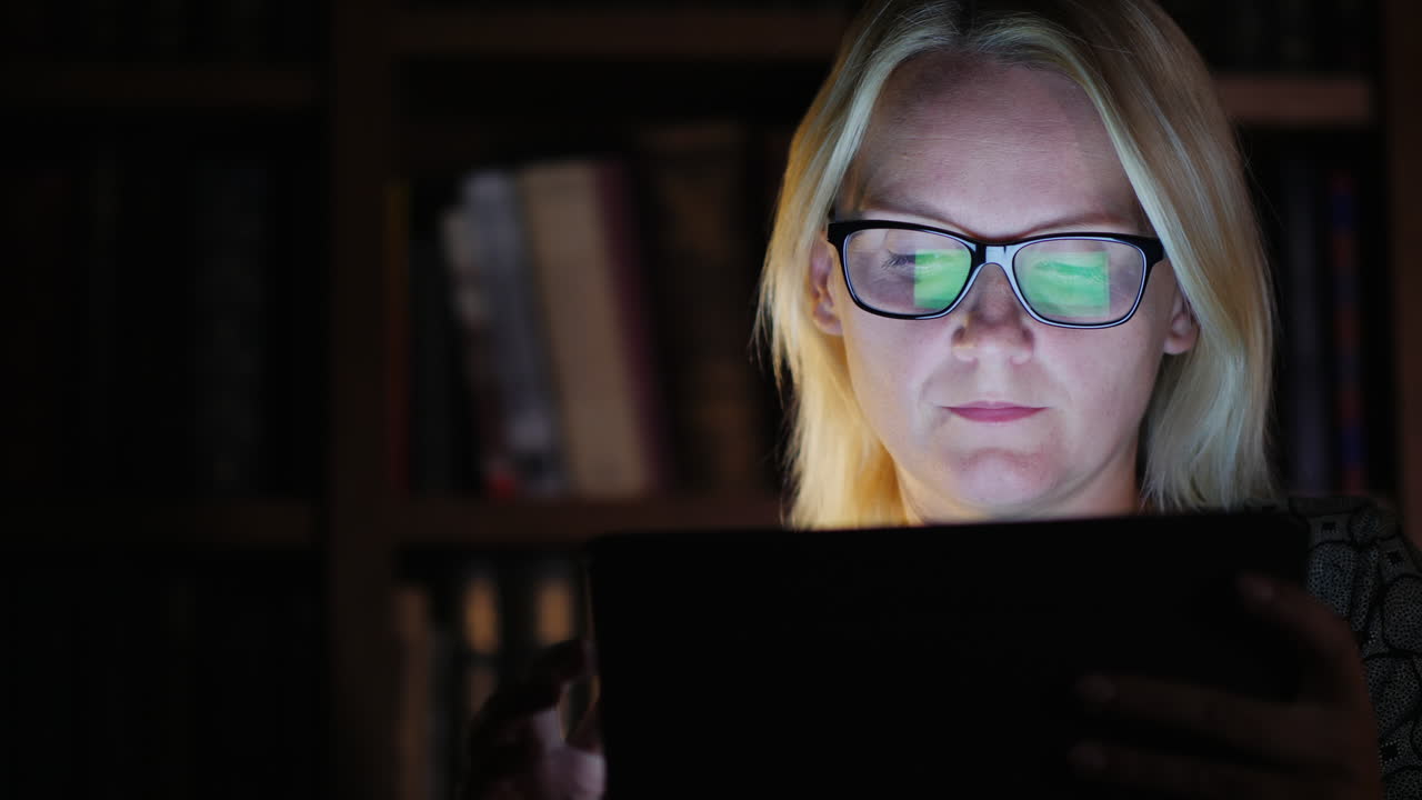 Woman in a Study With a Tablet Late At Night