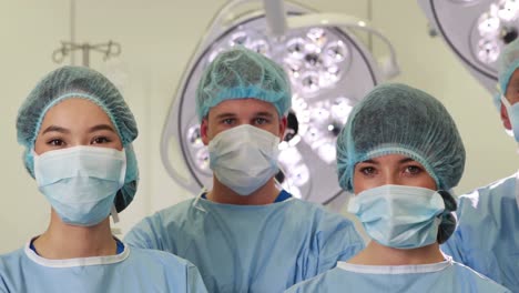 Surgical-team-looking-at-the-camera-in-operating-theater