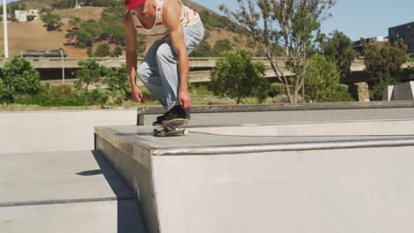 Caucasian-man-riding-and-jumping-on-skateboard-on-sunny-day