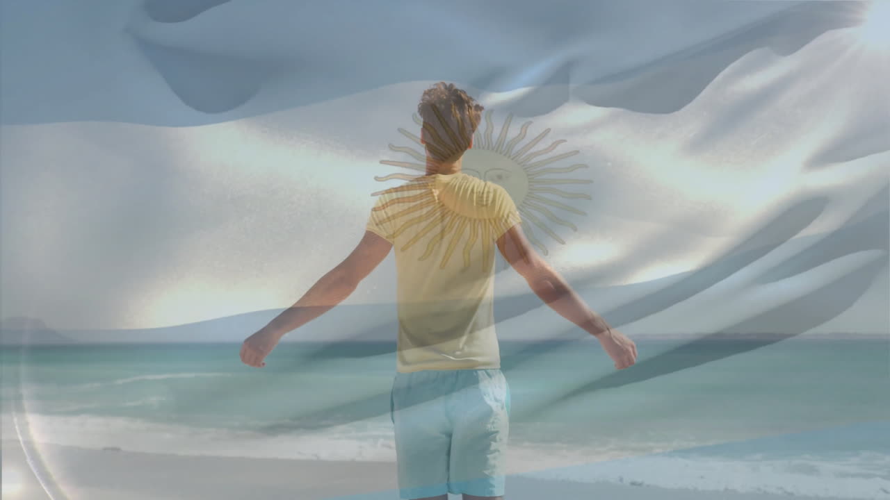 Standing on beach, man holding Argentina flag with sun emblem animation
