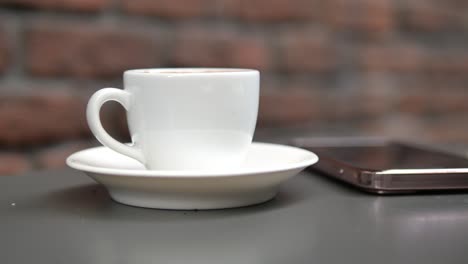 coffee cup and mobile phone on a table