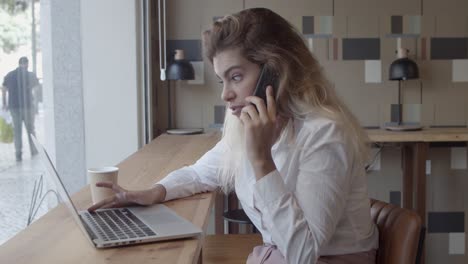 happy friendly female entrepreneur talking on cellphone