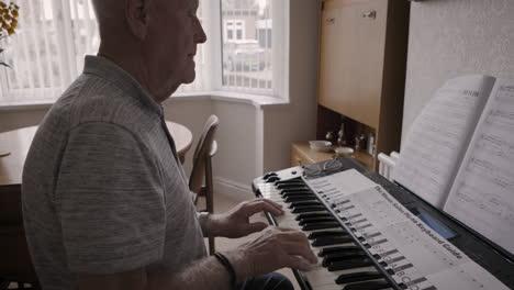 man playing piano at home