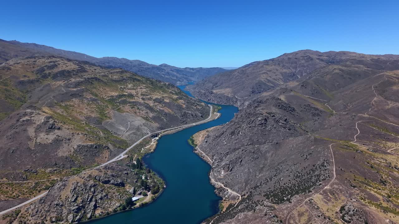 Epic river reveal aerial drone video delivers breathtaking landscape background of the mighty Clutha river in the cromwell gorge, showcasing natural New Zealand