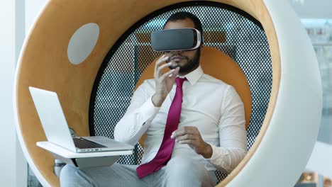 businessman using vr headset and laptop