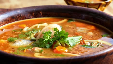 a steaming bowl of vegetable soup