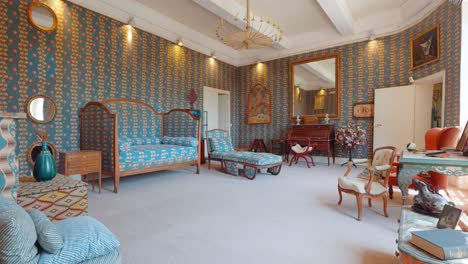 slow revealing shot showing a blue patterned living room within the chateau de castille