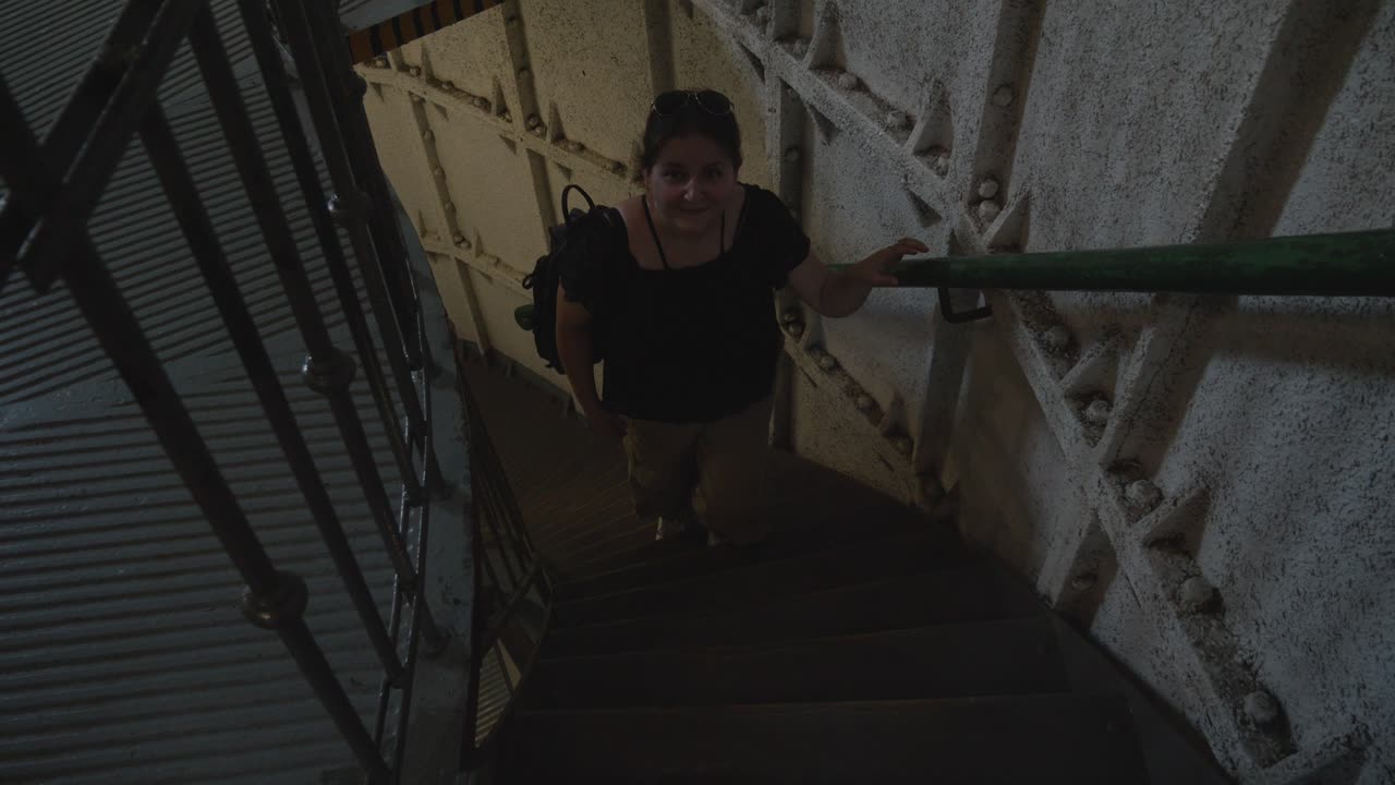 A woman ascends the stairs of the Stilo lighthouse in Stilo, Poland