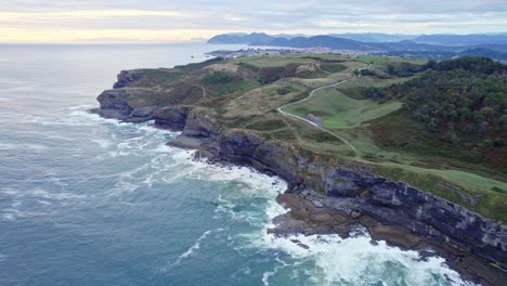 drone capture the aerial view of the green isla island and blue cantabrian sea from a great height