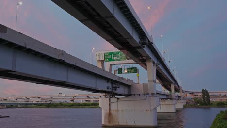 a night view of the intricate horikiri junction with streaks of light from flowing traffic on the expressway