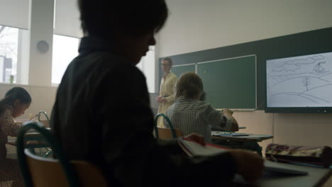 teacher talking information for students. children listening to schoolteacher