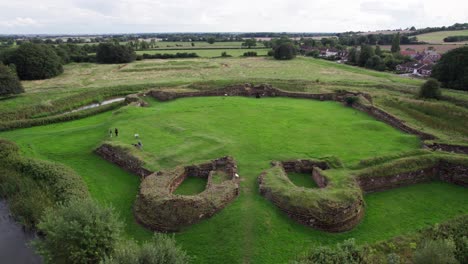 Aerial-video-footage-of-the-remains-of-Bolingbroke-Castle-a-13th-century-hexagonal-castle,-birthplace-of-the-future-King-Henry-IV,-with-adjacent-earthwork