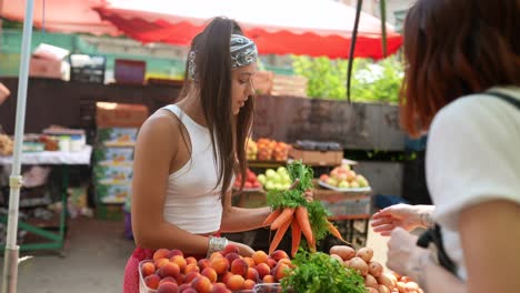 women shopping for fruits and vegetables at a market