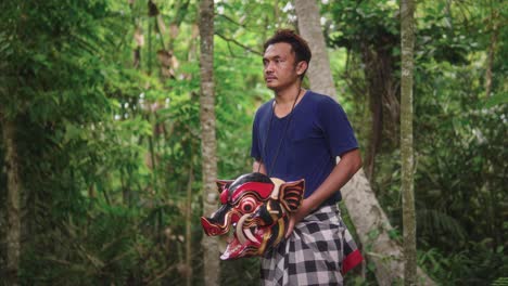 The-bold-face-of-a-traditional-Barong-Bangkung-dancer,-carrying-a-mask-brimming-with-mystical-tales-of-Balinese-culture