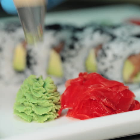 professional sushi-chef prepares rolls for the client in a commercial kitchen. serving sushi in a white plate sqare video