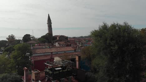 Aerial-view-of-panorama-of-painted-house-facades-of-Burano-island-a-province-of-Venice-in-Italy-in-a-sunny-day