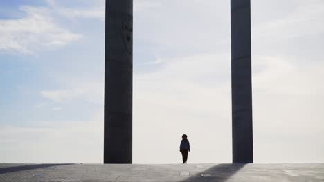 woman taking selfie near modern columns