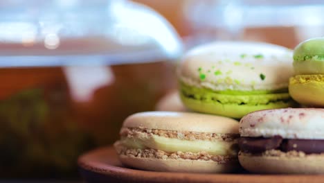 close-up of colorful macaron (macaroon) on the table with hot tea