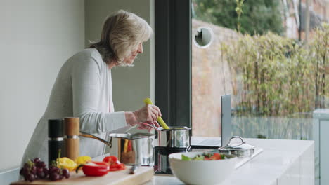 senior woman cooking in kitchen