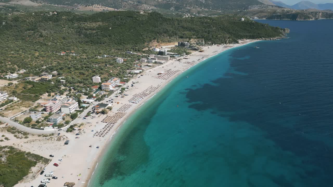Aerial reveal shot of pictoresque Livadi Beach with colorful ocean