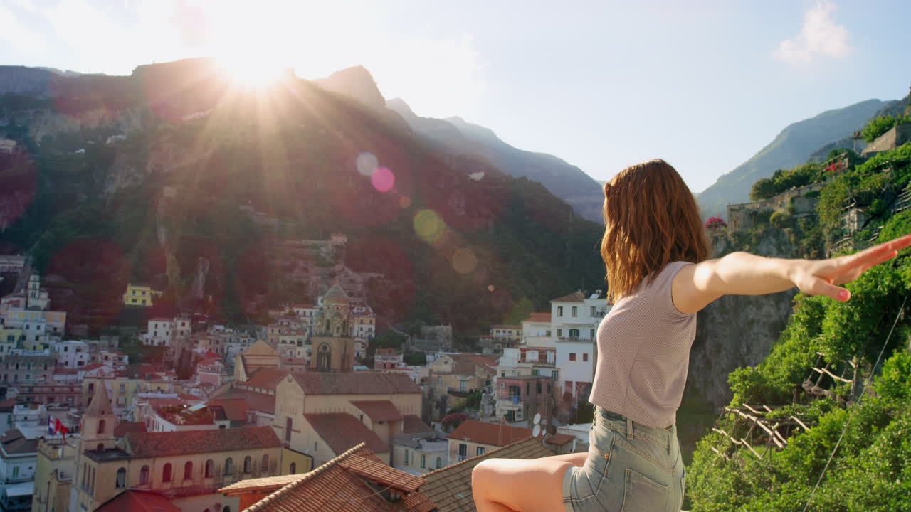 una mujer disfrutando de la vista del atardecer desde un techo en italia