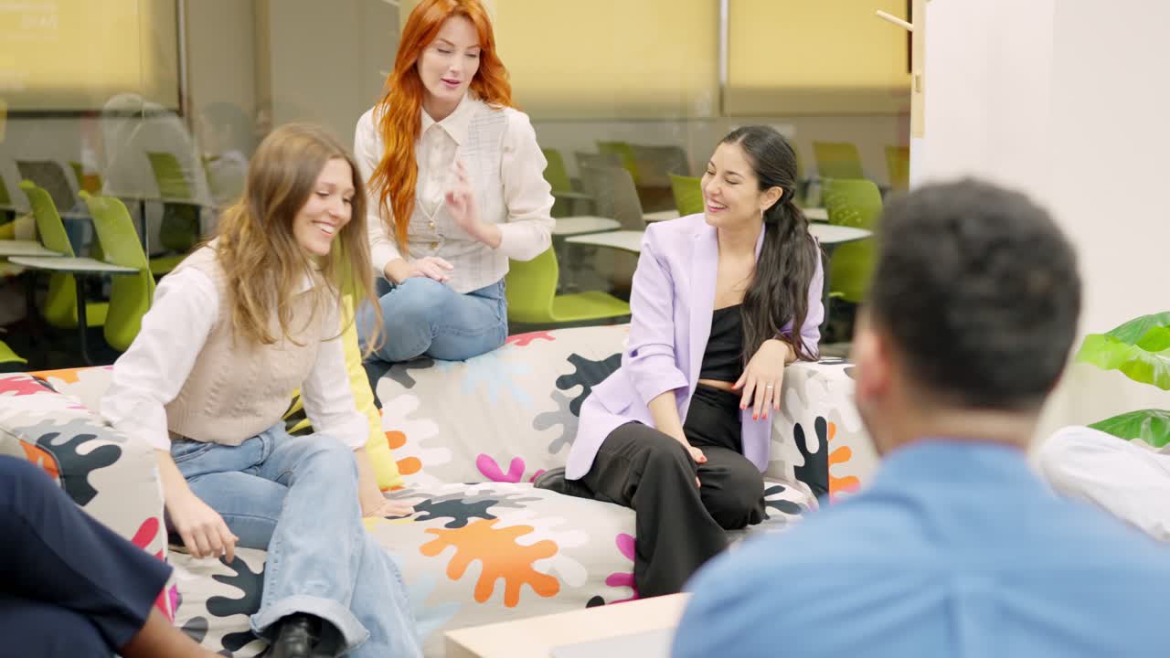 Women talking relaxed during a work break in a coworking