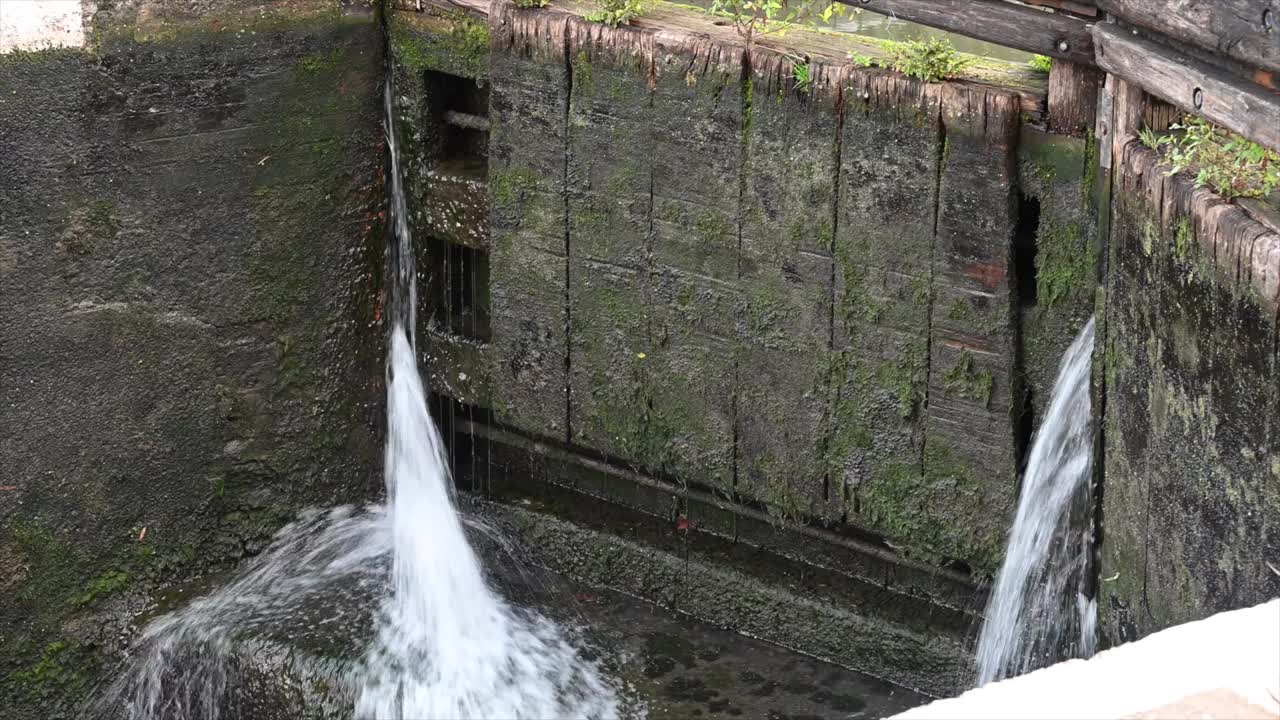 water leaking at a lock in england in london, urban canal