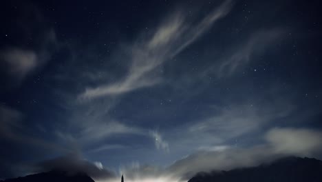 timelapse of hawaiian night sky with brilliant bright stars and fluffy white clouds over the koolau mountain rage on oahu hawaii