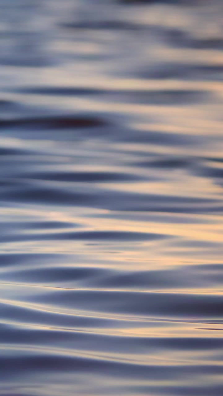 Close-Up of Calm Water Ripples with Colorful Reflections