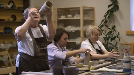 women learning pottery in a workshop