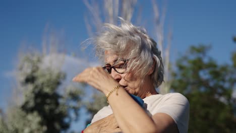 exhausted senior woman cooling off on a hot day