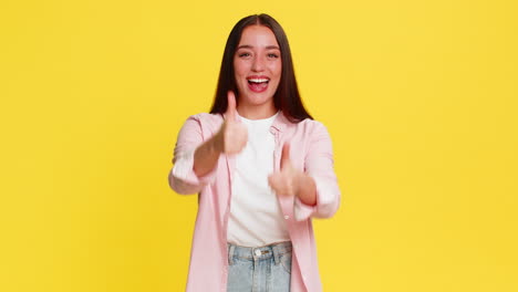 woman celebrating victory with joyful excited expression hands raised cheerful emotional happy mood