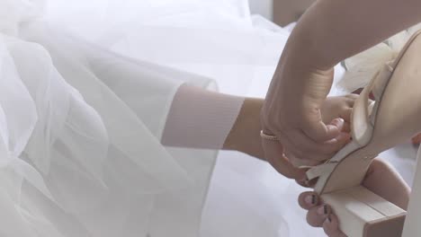 Bride-getting-shoes-put-on