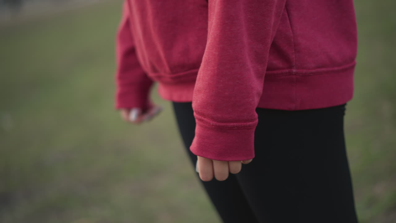 Runner Checking Watch, Athlete Preparing For Exercise, Runner In Hoodie Examines Watch Before Exercise Session, Individual In Red Hoodie Assessing Time And Pulse Before Starting Workout