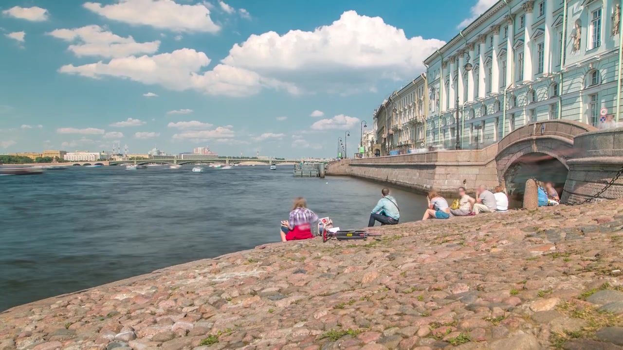 Folk på Eremitagebroen og Neva-flodens trapper timelapse med en turistbåd på Vinterkanalen i baggrunden. Sankt Petersborg, Rusland
